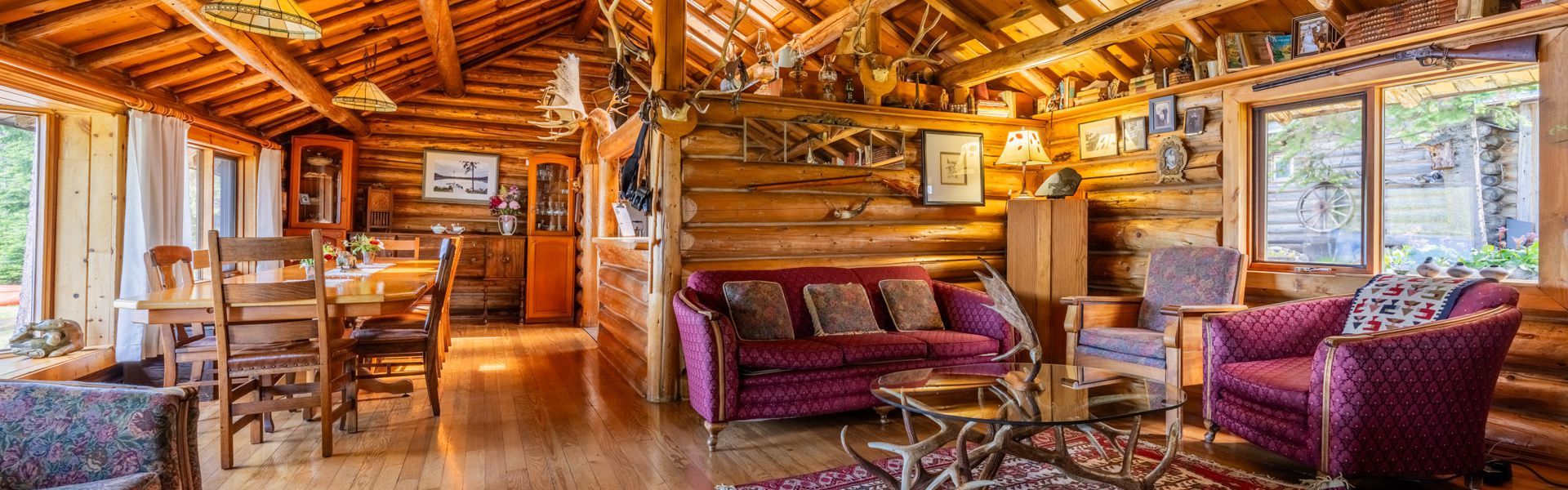 Interior of the main lodge at Caverhill, showing the rustic log walls and decor.